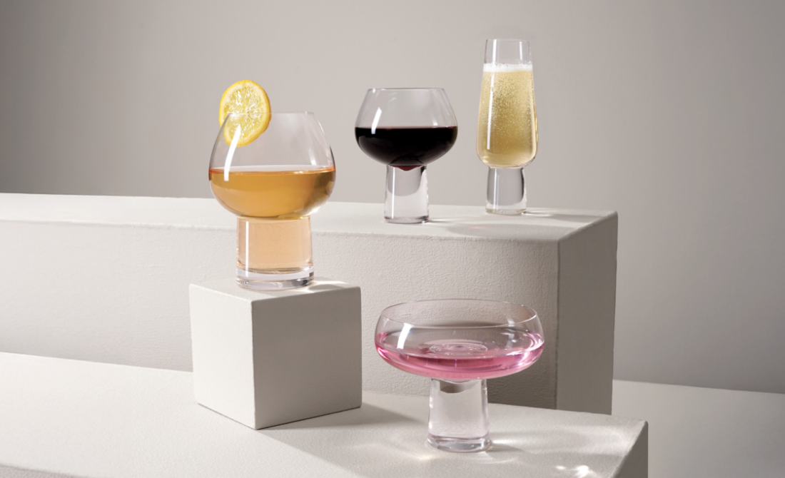 Stylish office accessories a metal pen holder with face design and a clock, with a blue and teal background.