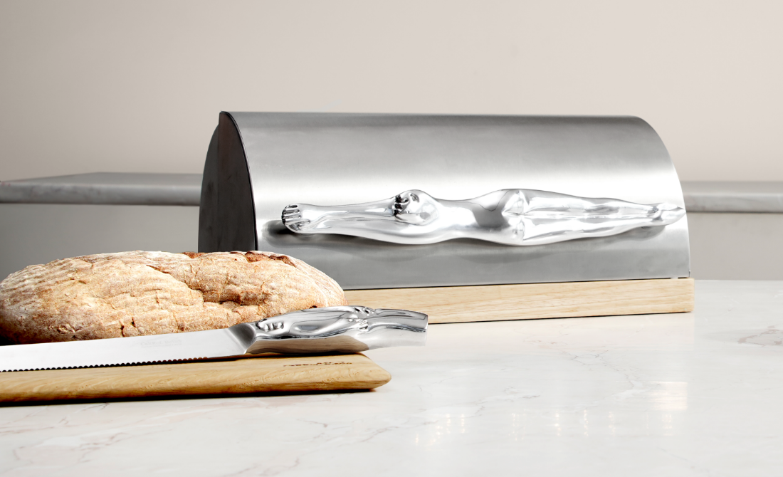 Stylish office accessories a metal pen holder with face design and a clock, with a blue and teal background.