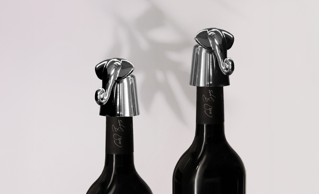 Elegant office accessories including a polished metal business card holder, letter opener, and pen holder with elephant designs.