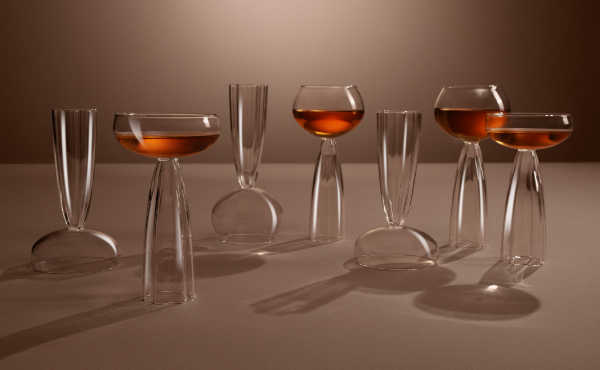 Stylish office accessories a metal pen holder with face design and a clock, with a blue and teal background.