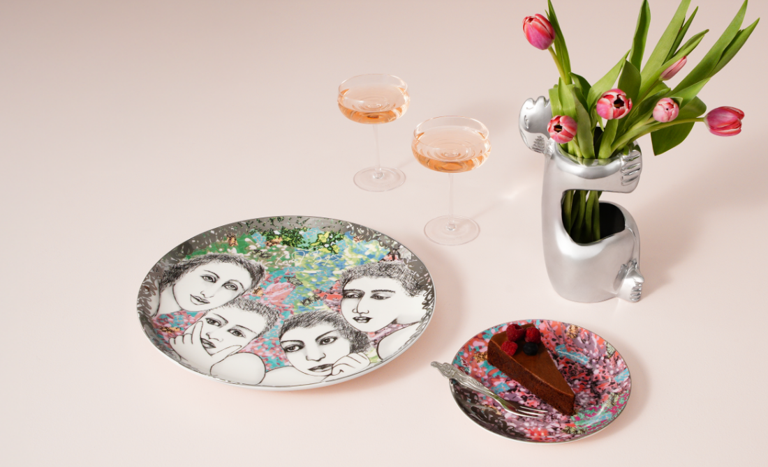 Stylish office accessories a metal pen holder with face design and a clock, with a blue and teal background.