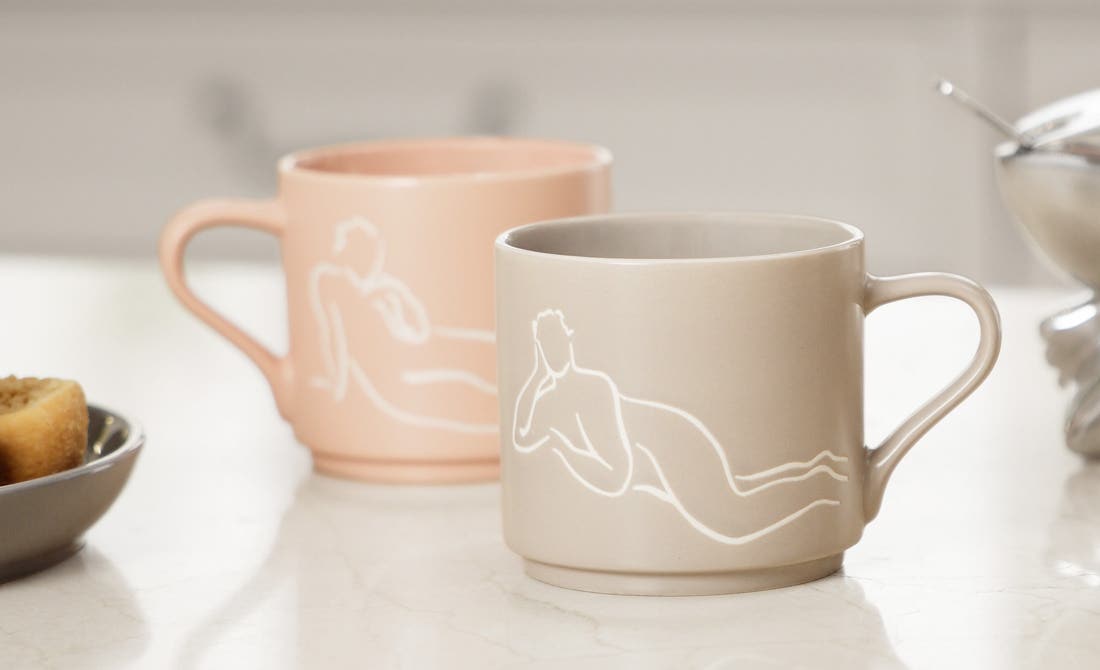 Stylish office accessories a metal pen holder with face design and a clock, with a blue and teal background.