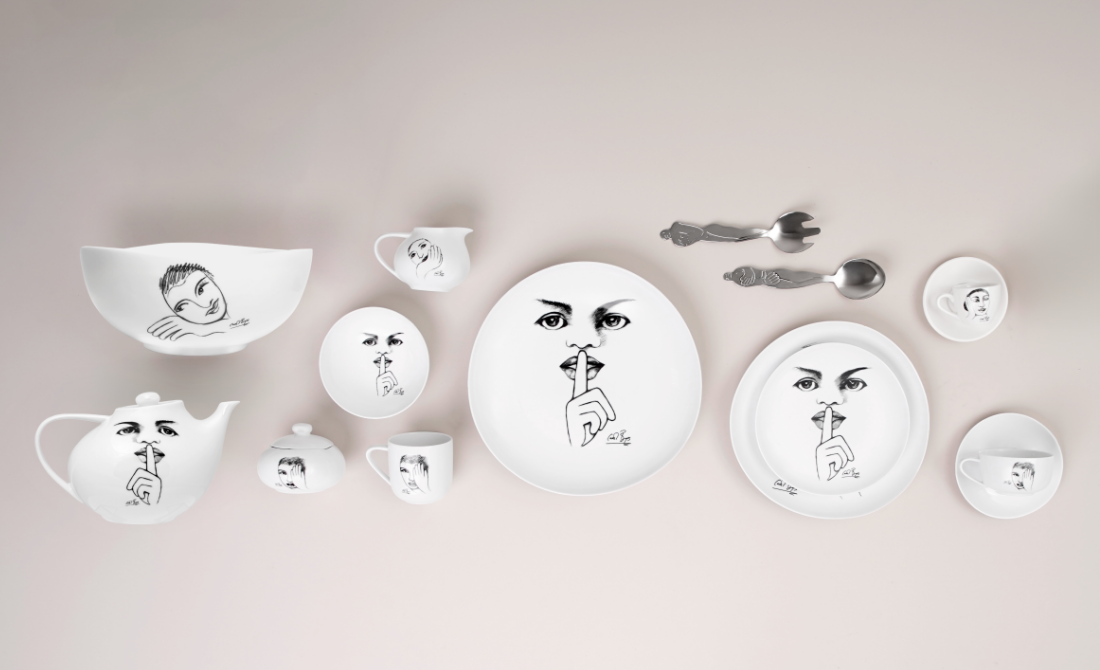 Collection of white ceramic dinnerware with artistic face sketches, including plates, bowls, and a mug.