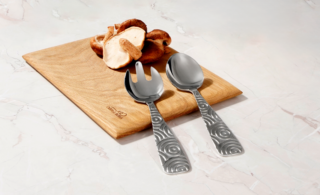 Stylish office accessories a metal pen holder with face design and a clock, with a blue and teal background.