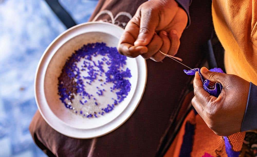 A MonkeyBiz banner featuring beaded animal sculptures