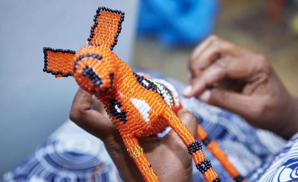 A MonkeyBiz banner with a collection of colorful beaded items